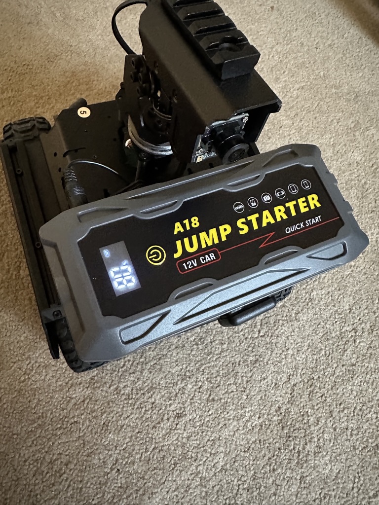 Close-up of the 12V jump-starter battery pack powering the rover