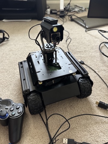Close-up of the camera gimbal next to the wireless controller used for manual teleop